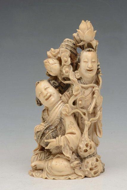 Appraisal: A CHINESE CARVED IVORY OKIMONO in the form of two