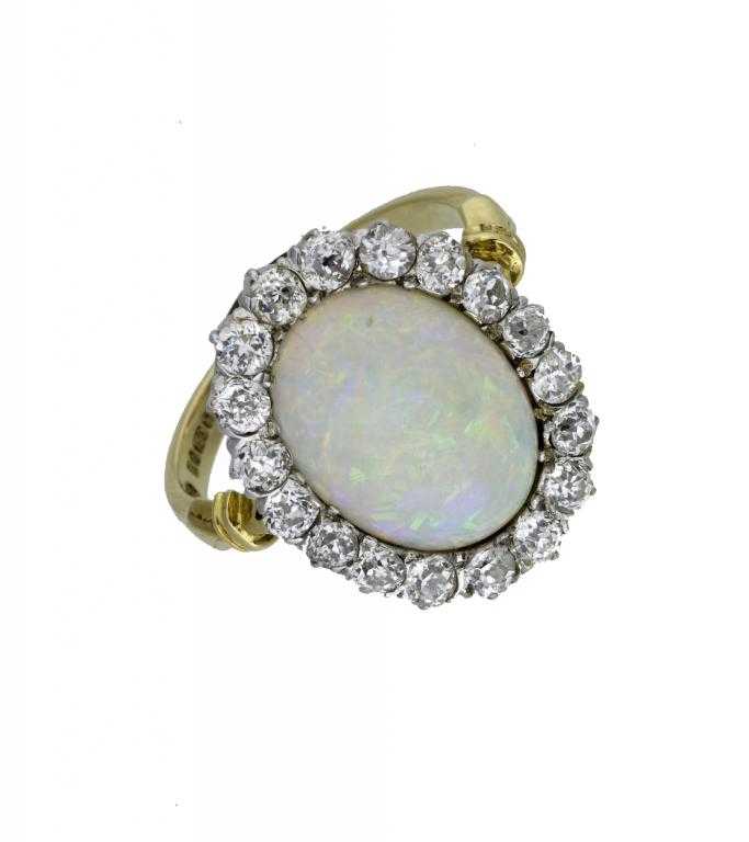 Appraisal: AN OPAL AND DIAMOND CLUSTER RING with surround of evenly