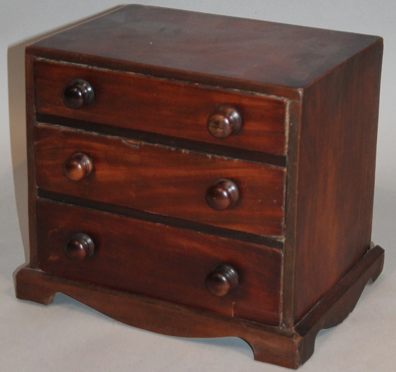 Appraisal: An early thC mahogany miniature chest the square outline raised