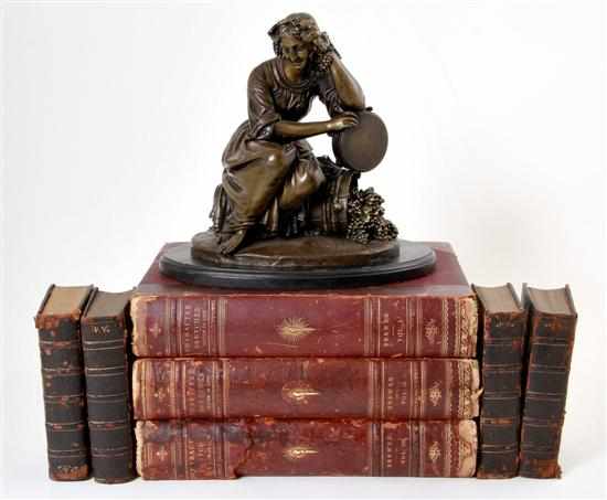 Appraisal: Collection of leatherbound books and figural sculpture bronze sculpture depicting