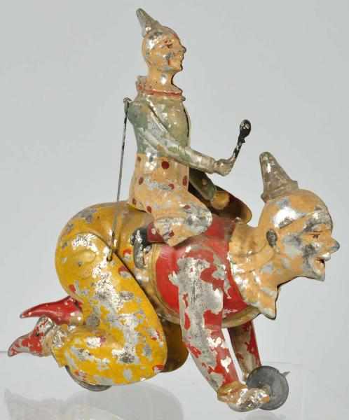 Appraisal: Tin Gunthermann Clown Riding Clown Wind-Up Toy Description German Working