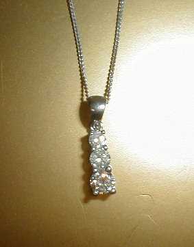 Appraisal: A three stone graduated diamond pendant total approx ct set