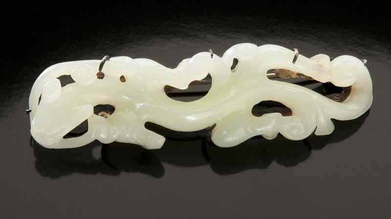 Appraisal: Chinese carved white jade and sterling silverbrooch depicting a chi