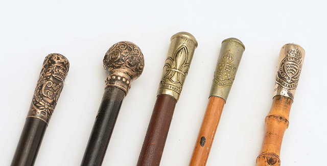 Appraisal: FOUR REGIMENTAL SWAGGER STICKS with crests to include silver topped