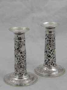 Appraisal: A pair of Chinese silver candlesticks the columns pierced as