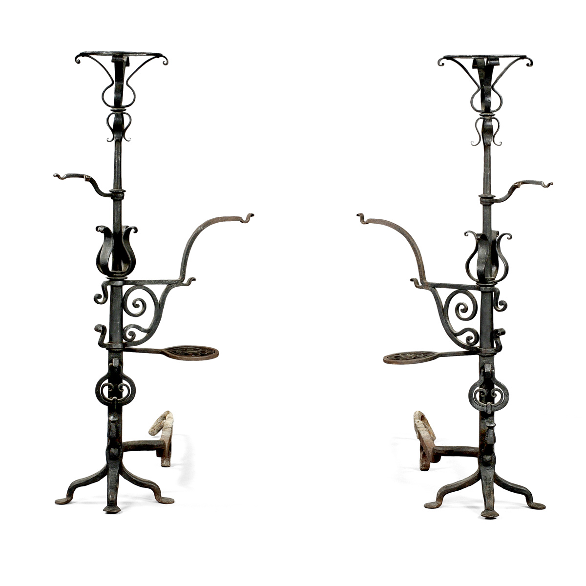 Appraisal: PAIR OF WROUGHT-IRON TORCHERE ANDIRONS EARLY TWENTIETH CENTURY Each standard