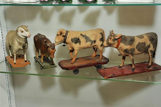 Appraisal: FOUR PULL TOYS Including two cows a bull and a