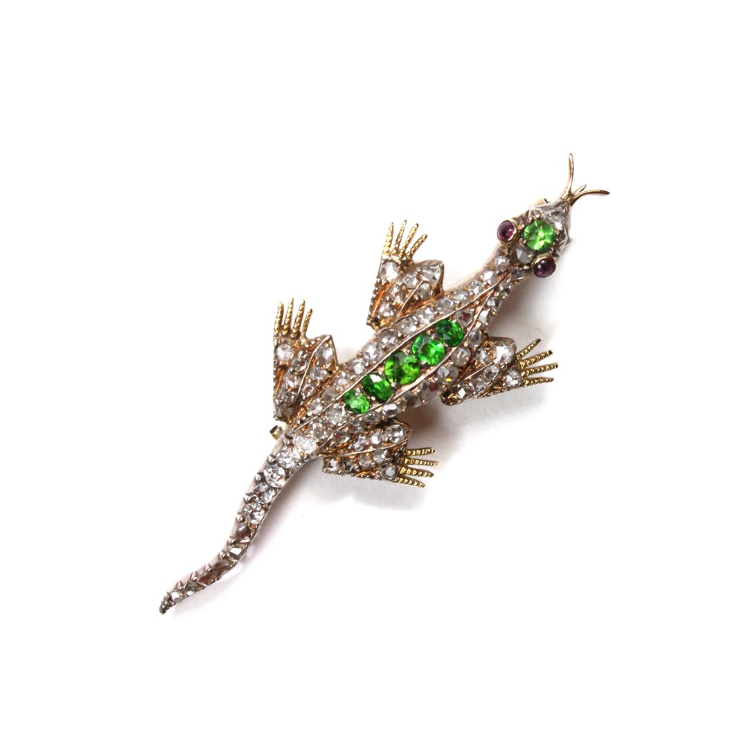 Appraisal: A diamond and demantoid garnet set brooch designed as a