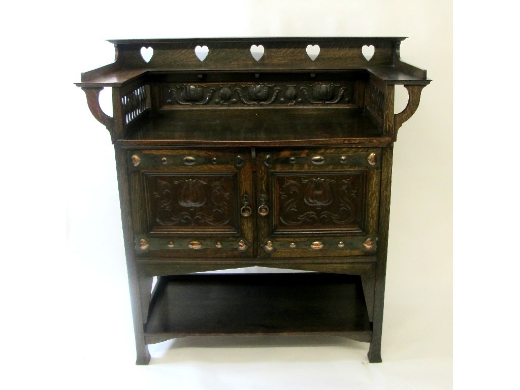 Appraisal: An Arts and Crafts Liberty style oak sideboard by Wylie