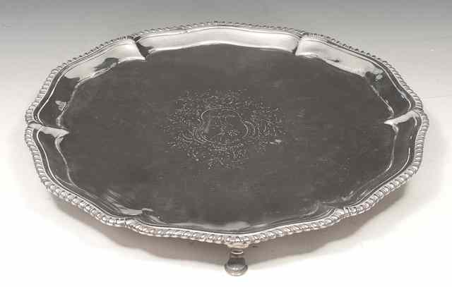 Appraisal: A GEORGE II SILVER SALVER with shaped gadrooned edge and