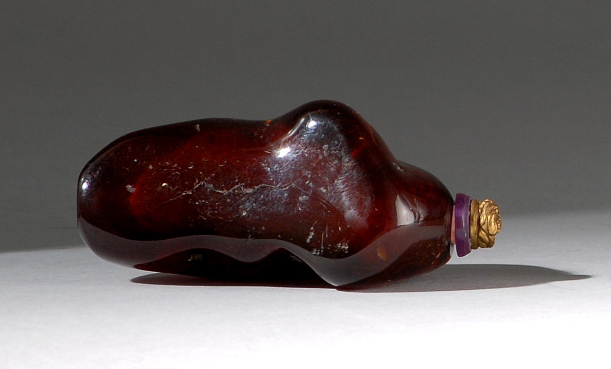 Appraisal: AMBER SNUFF BOTTLE th CenturyIn pebble form with delightful natural