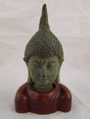 Appraisal: A bronze Tibetan Buddha head ht cm on hardwood stand