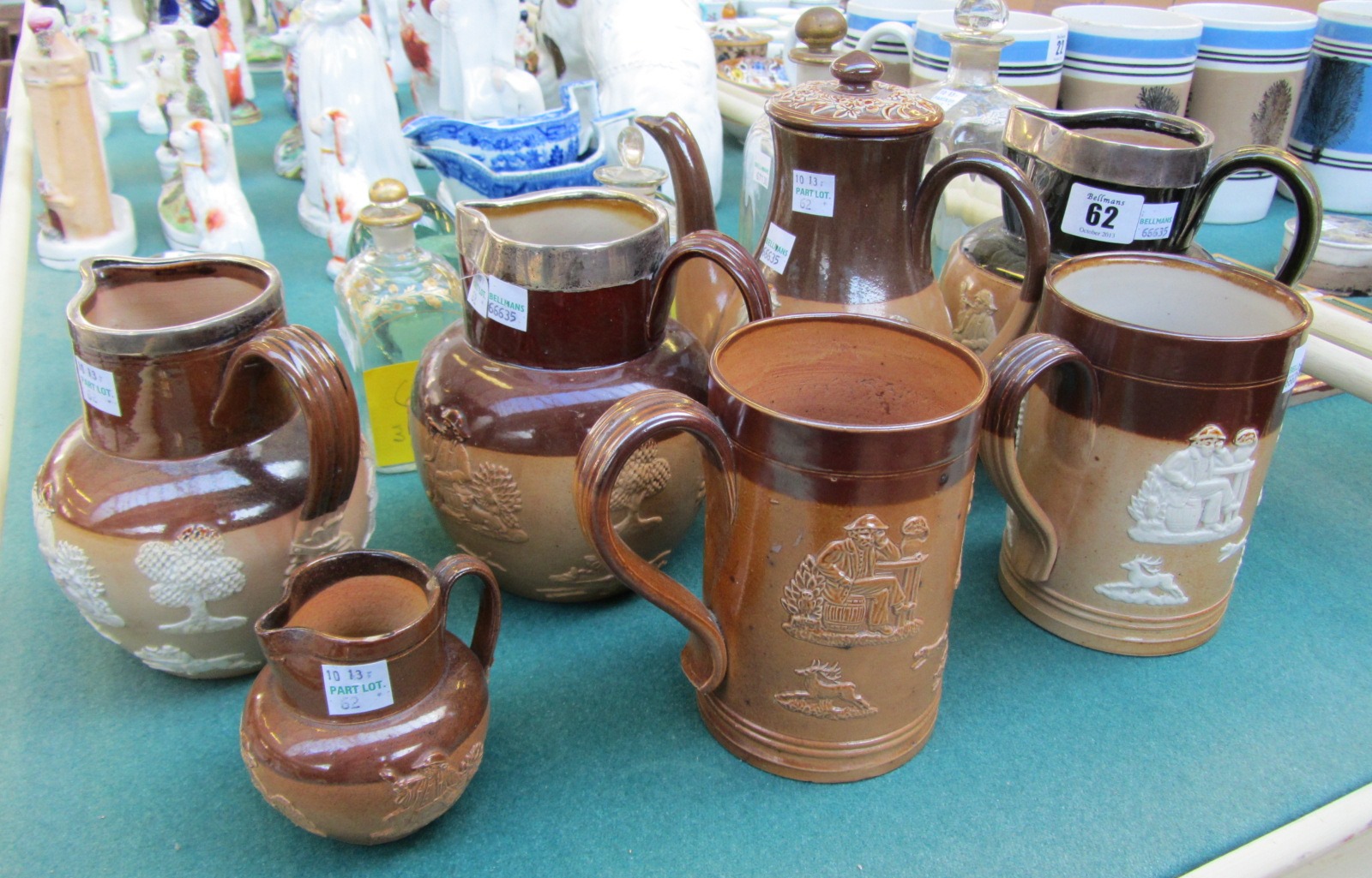 Appraisal: Three silver mounted Doulton harvest ware jugs cm high a