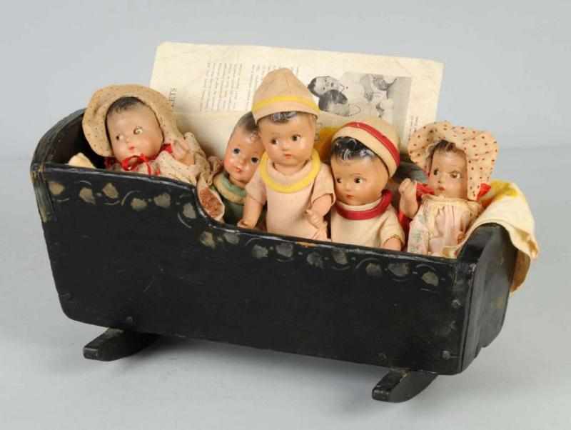 Appraisal: Composition Quintuplets in Wood Cradle Description Unmarked composition babies in