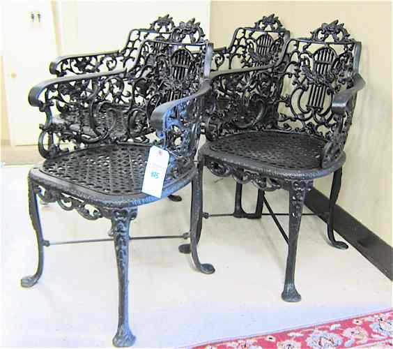 Appraisal: A SET OF FOUR GARDEN ARMCHAIRS black cast iron classic