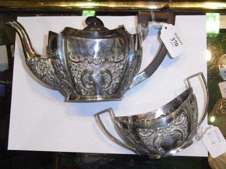 Appraisal: A SILVER EMBOSSED TEAPOT and a matching two-handled sugar basin