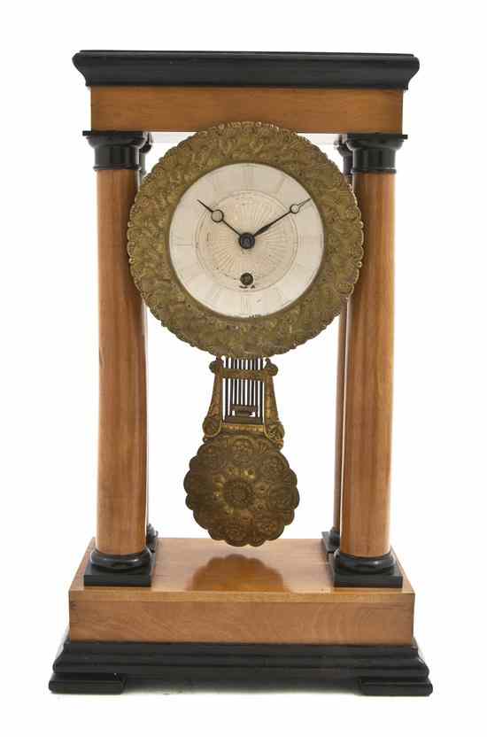 Appraisal: An Empire Parcel Ebonized Portico Clock having a rectangular top