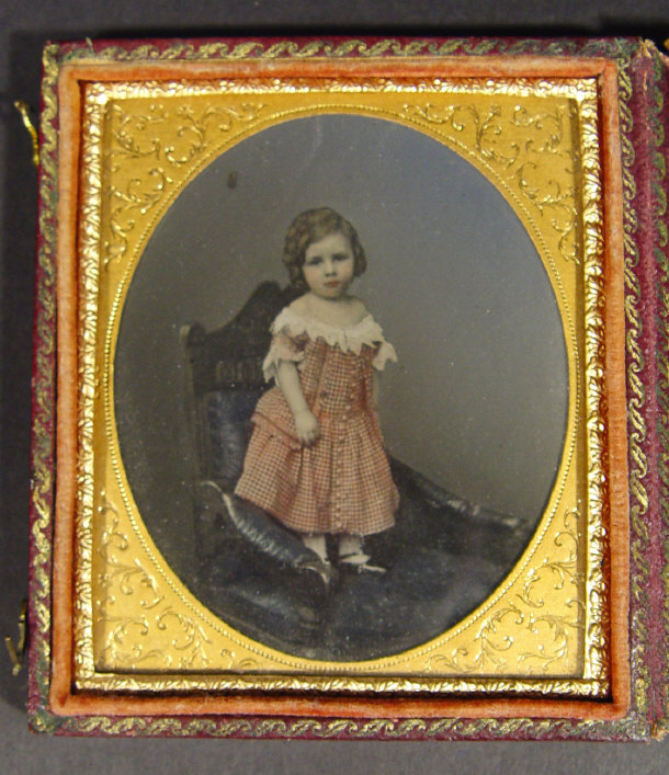 Appraisal: Victorian hand coloured oval photograph of a young child in