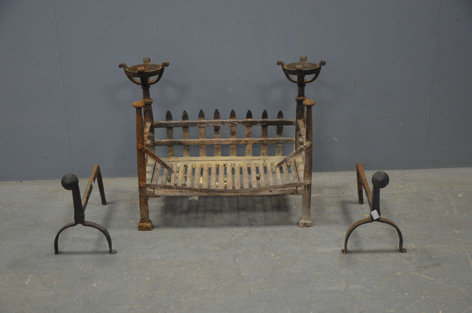 Appraisal: Cast iron fire grate together with two andirons