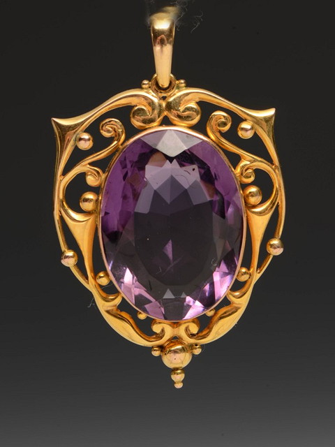 Appraisal: AN AMETHYST PENDANT of oval form with pierced stylised setting