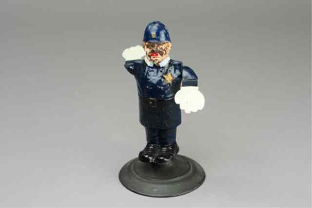 Appraisal: TRAFFIC COP WHIRLYGIG FIGURE Tin body articulated arms painted in