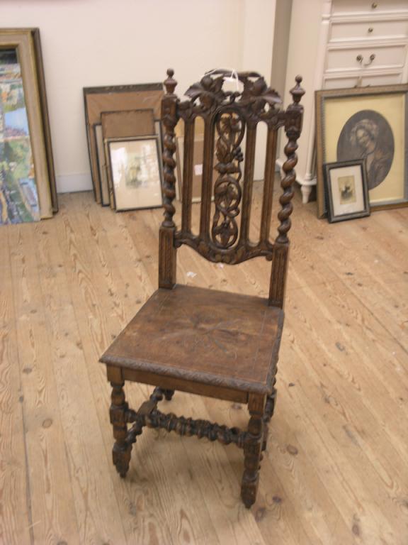 Appraisal: A late Victorian oak hall chair with carved back and