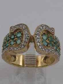 Appraisal: A hallmarked ct gold emerald and diamond ring with ''C''