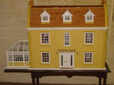 Appraisal: A late th century doll's house painted wood construction with