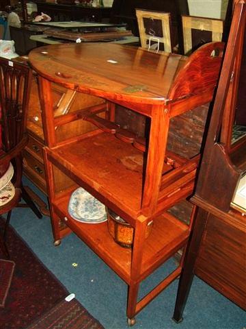 Appraisal: A metamorphic tea trolley together with a brass inlaid Indian