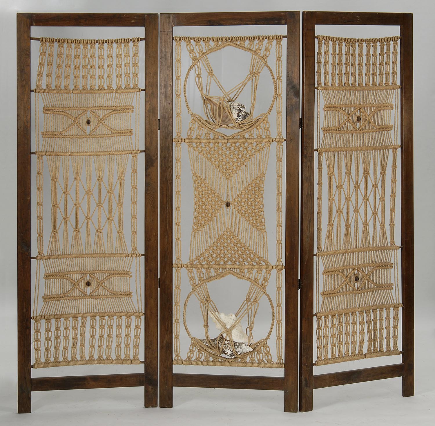 Appraisal: THREE-PANEL WOOD-FRAMED SCREEN with macram panels Central panel has netting