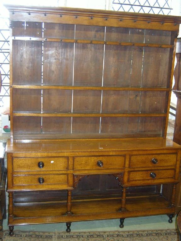 Appraisal: A Georgian oak Welsh pot board dresser fitted with an