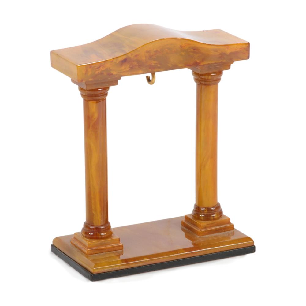 Appraisal: BAKELITE CARVED BUTTERSCOTCH MARBLED POCKET WATCH STAND WITH ROMAN COLUMNS