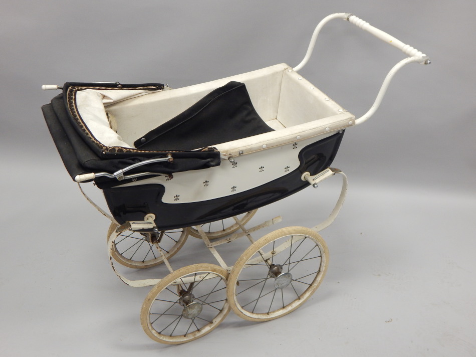 Appraisal: A Silver Cross coach built pram decorated in black and