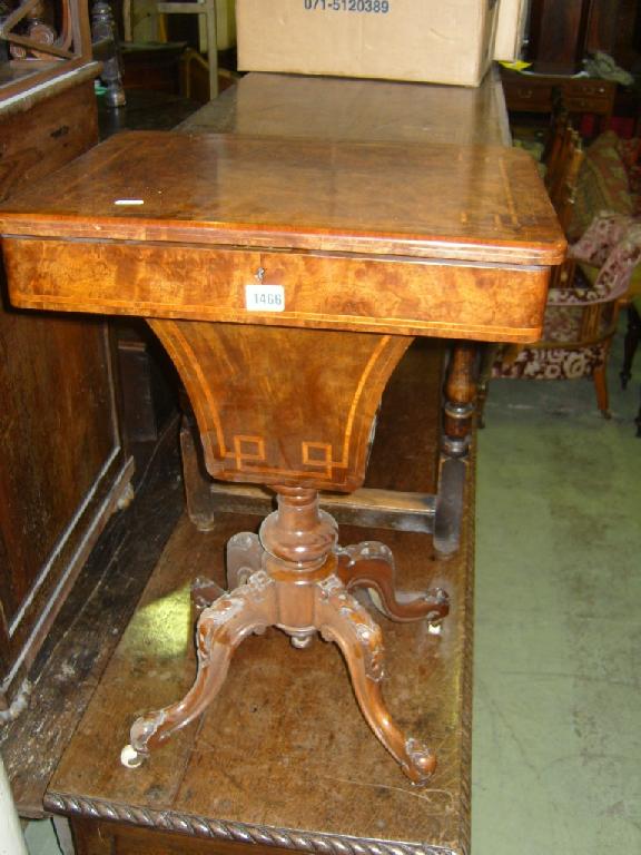 Appraisal: A Victorian walnut sewing table the rising lid enclosing a