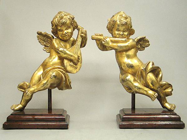 Appraisal: A pair of Baroque style giltwood figures of putti playing