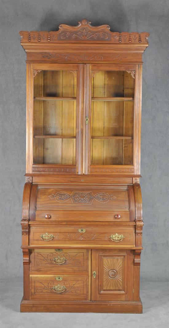 Appraisal: Walnut Cylinder Desk Bookcase Circa Carved cylinder enclosing sliding leather