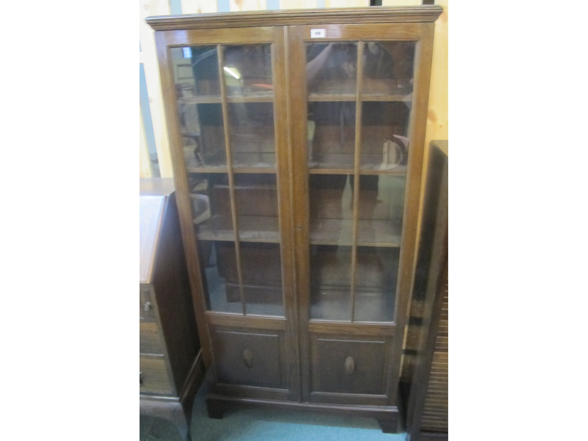 Appraisal: An oak glazed two door bookcase