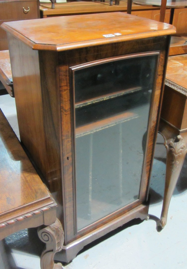 Appraisal: A late Victorian music cabinet with a single glazed door