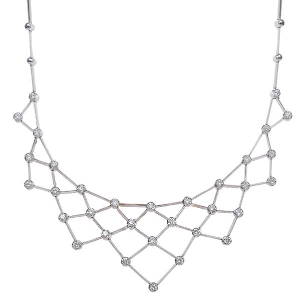 Appraisal: A DIAMOND NECKLACE The bib style open lattice work necklace