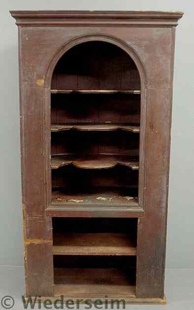 Appraisal: Pine barrel-back one-piece cupboard th c with scalloped shelves lacking