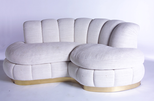 Appraisal: 's Kidney-shaped sofa with rolled back and deeply-tufted ivory chenille