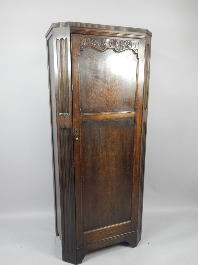 Appraisal: An oak early thC hall cupboard with floriate carving single