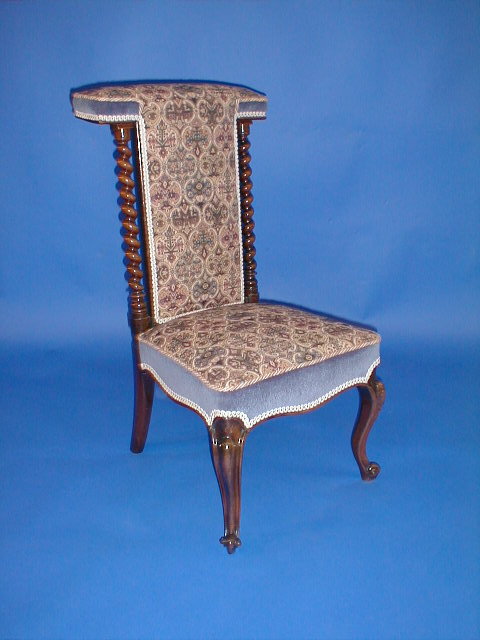 Appraisal: A Victorian rose wood prie-dieu chair with barley twist supports