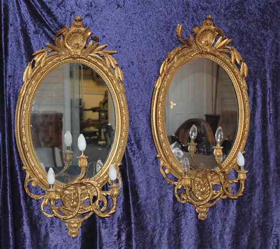 Appraisal: A pair of Victorian carved giltwood and gesso oval girandoles