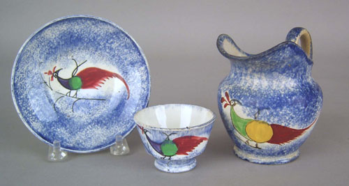 Appraisal: Miniature blue spatter cup and saucer th c with peafowl