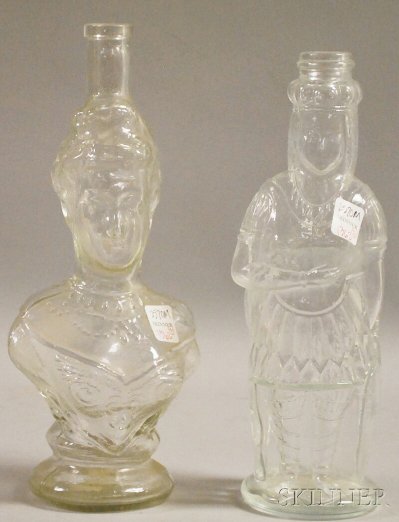 Appraisal: Two Colorless Molded Glass Figural Bottles th century including a