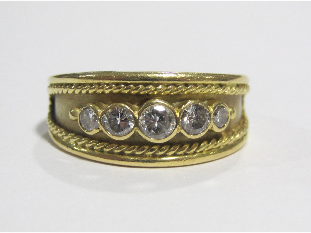 Appraisal: An Eighteen carat gold five stone diamond set band with