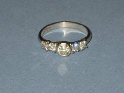 Appraisal: A FIVE STONE DIAMOND RING the central brilliant cut diamond