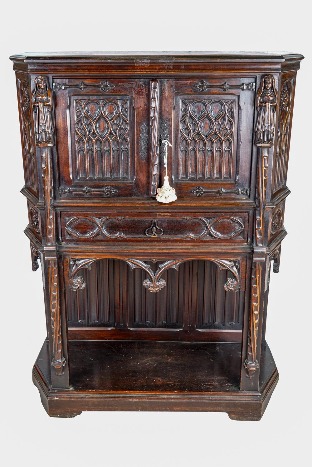 Appraisal: GOTHIC-STYLE CARVED WOOD RADIO CABINETthe hinged doors concealing a Marti