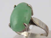 Appraisal: A cabochon jade ring the jade measuring approx x mm